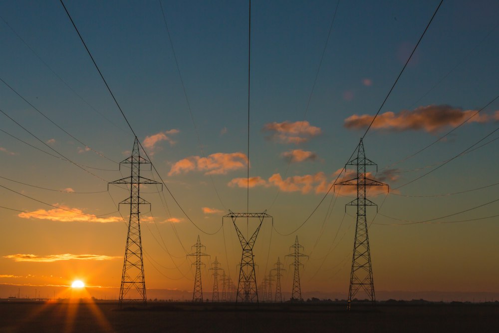 Electricity transmission lines at sunset, representing energy infrastructure